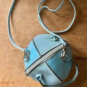 Spherical handbag with handles, strap, interior pocket